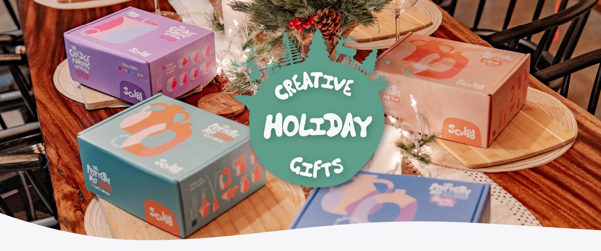 Sculpd Pottery Kits for Two and Sculpd Candle Making Kit for Two boxes laid out on a holiday-themed table, image is overlaid with the words Creative Holiday Gifts