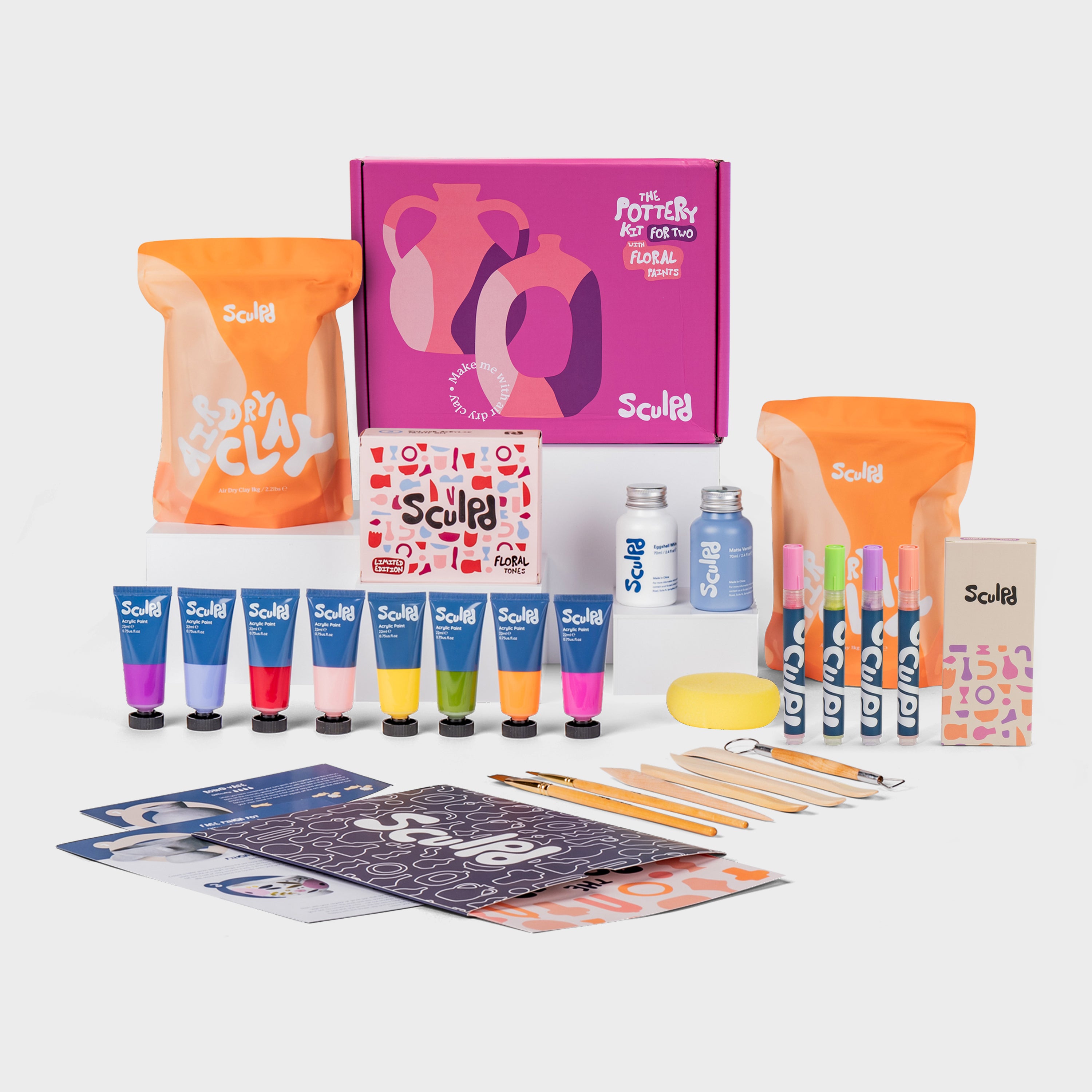 Sculpd pottery kit for two in a pink box with floral paints, and Modernist pens set