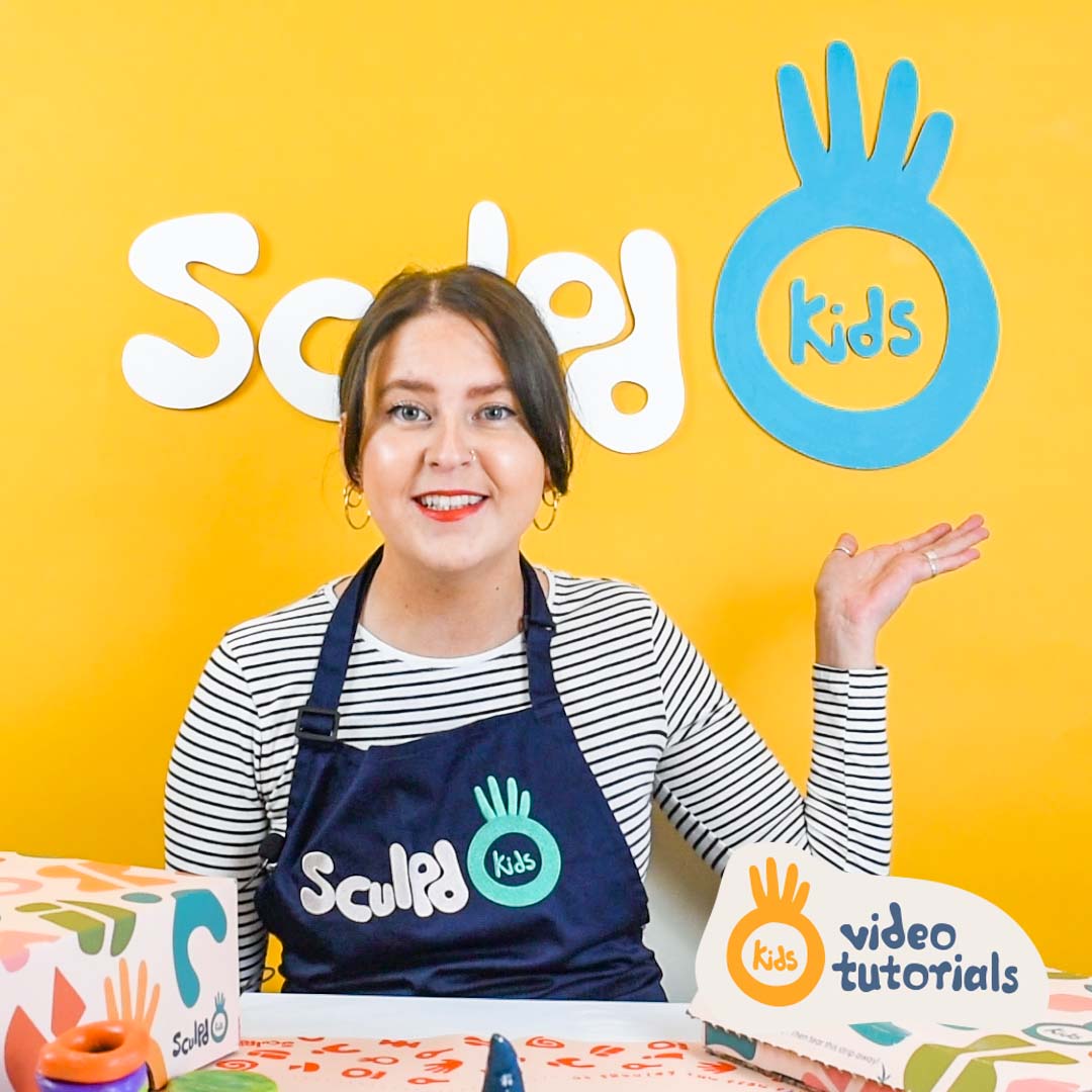 A cheerful instructor in a Sculpd Kids apron presenting against a bright yellow background for Sculpd Kids video tutorials