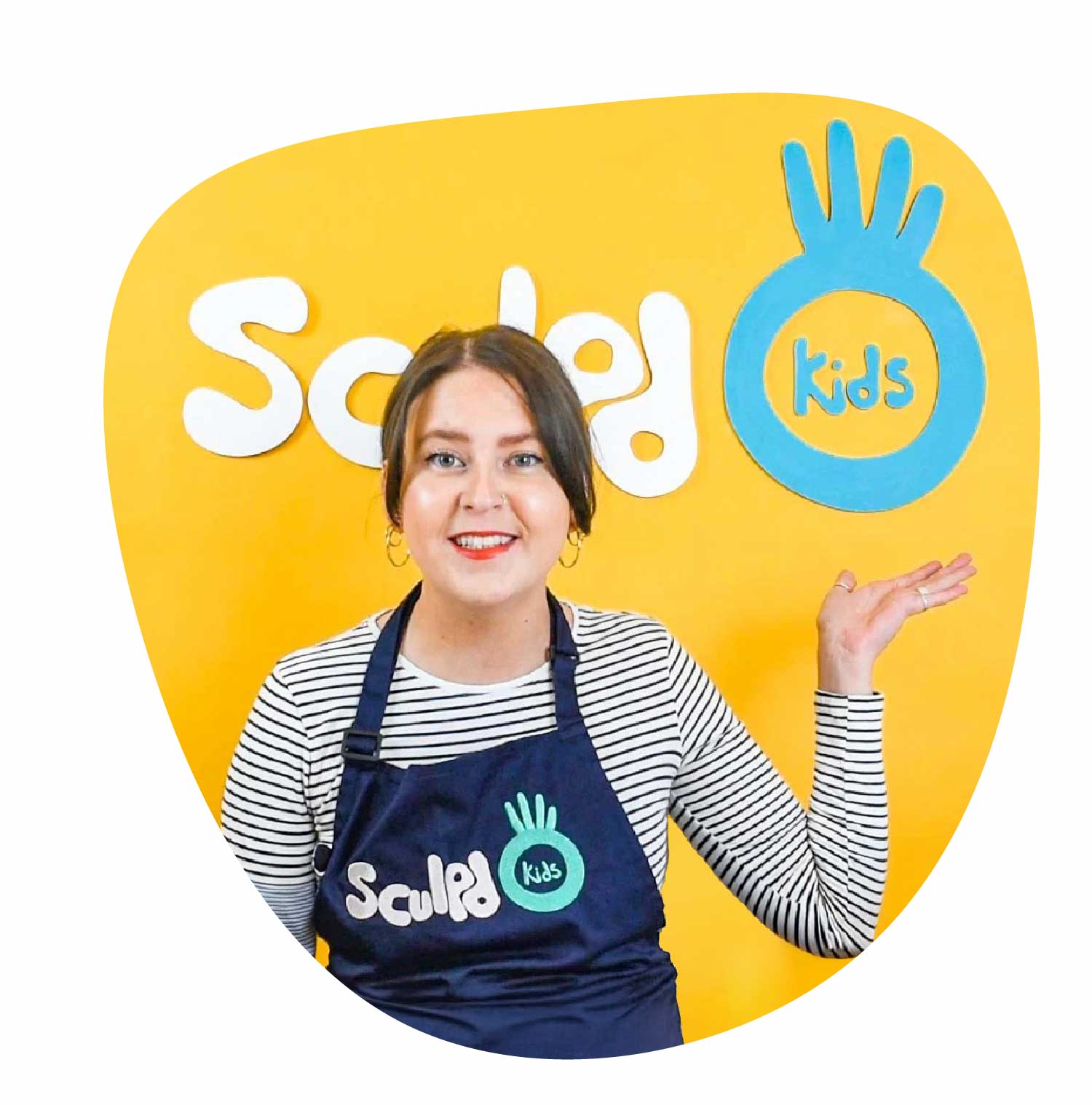 Sculpd Kids instructor in front of a big Sculpd logo sign