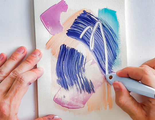 A person using a Palette knife to trace shapes over a painting on a canvas on a table